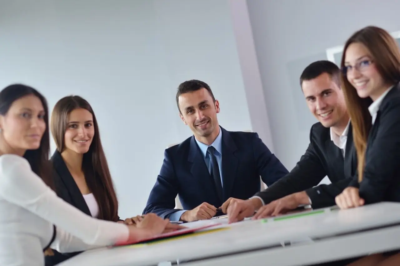 Smiling business team seated together at a meeting table